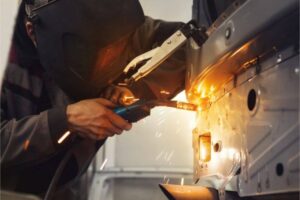 welder fixing a car